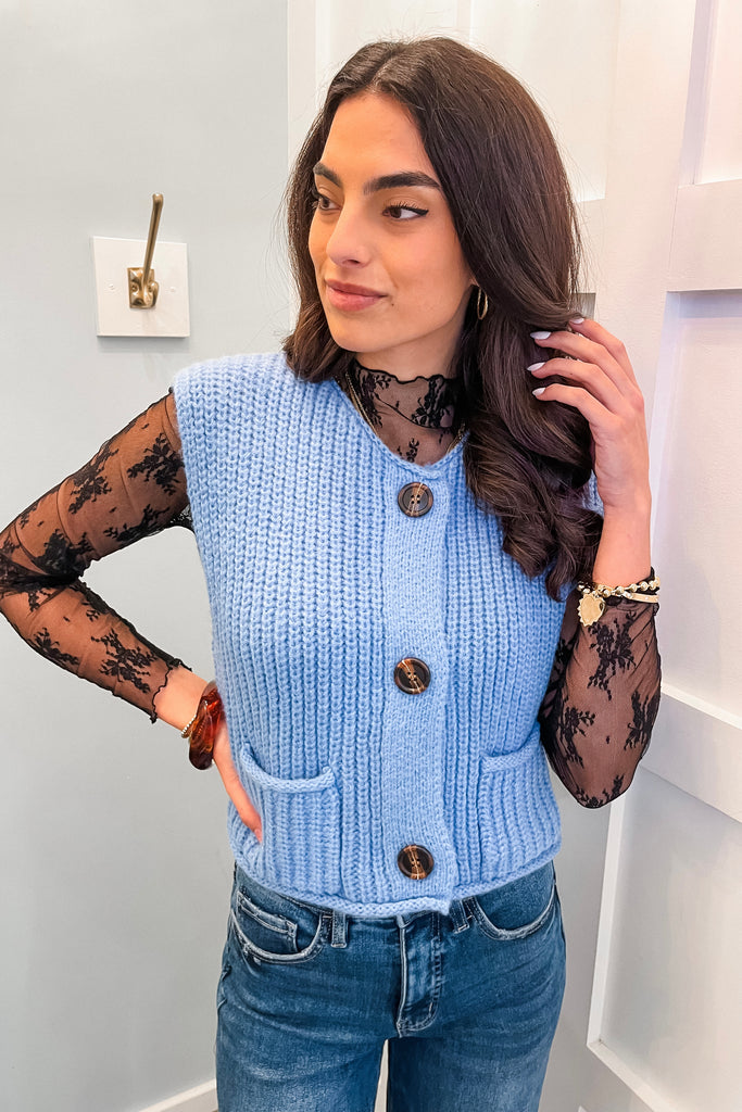 blue knit sweater vest with tortoise buttons