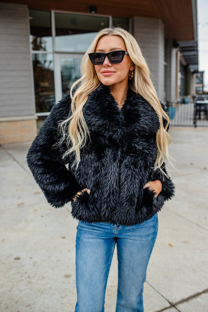 black faux fur coat